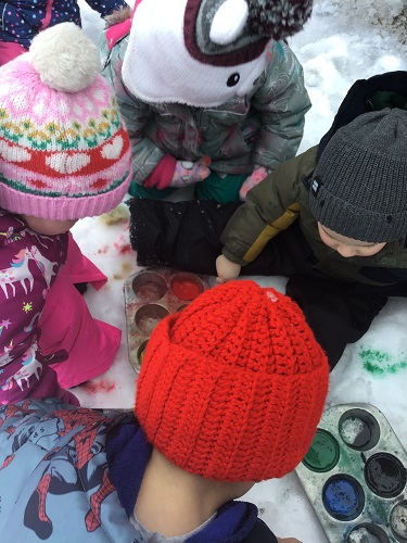 Toddlers painting the snow