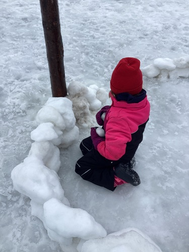 school-age child making base of fort