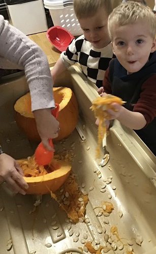 Children exploring the insides of a pumpkin
