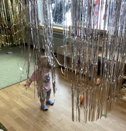 A child walking through the tinsel