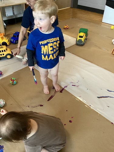 Children painting all over the classroom