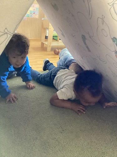 Children crawling under the folded "Nugget"