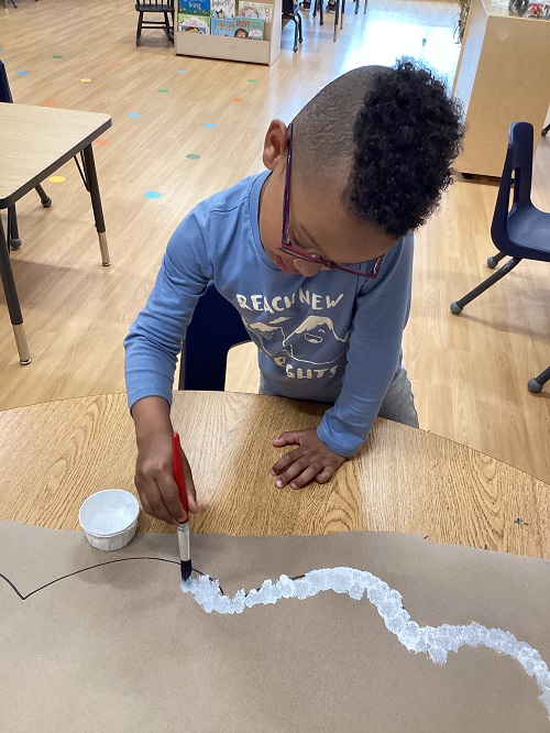 A school age child working on an art project