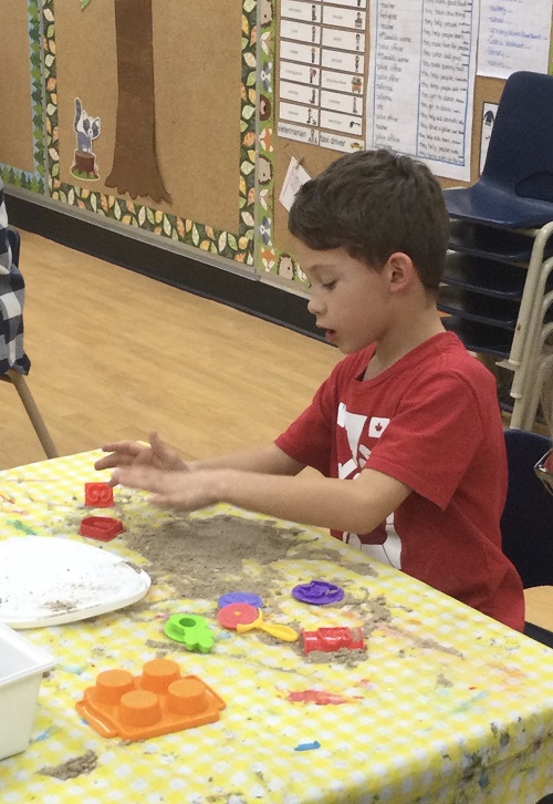 Child creating at table 
