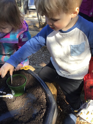 child digging in soil