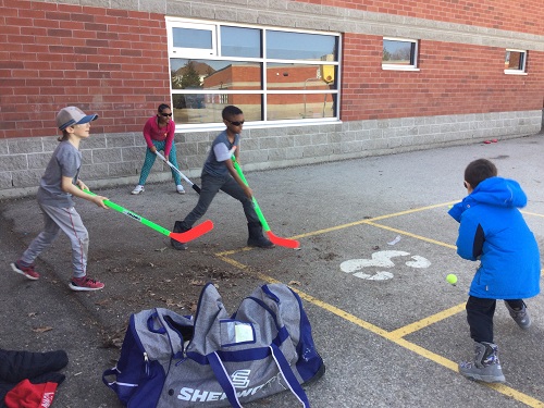 group of school age friends playing hockey