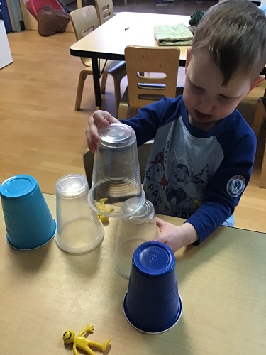 preschool boy stacking cups