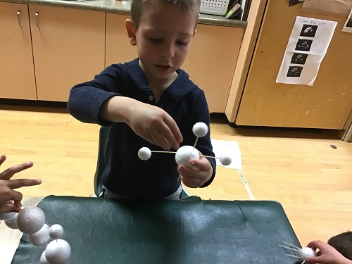 JK boy using big and small foam balls with toothpicks