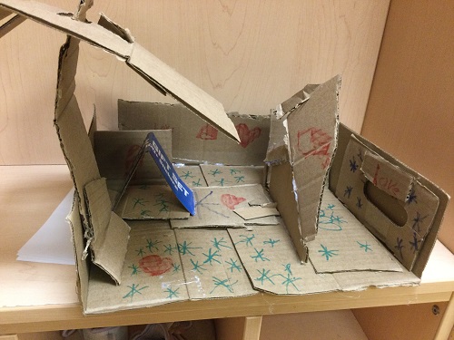 Cardboard gingerbread house made by school-age child 