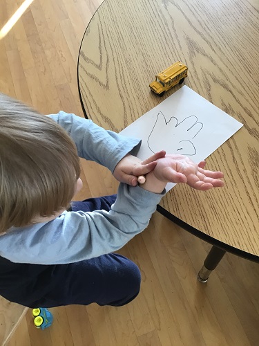 Toddler child tracing hand 