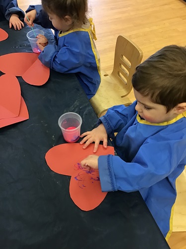 Toddlers decorating hearts