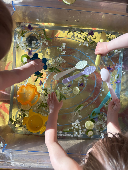 A child sitting and holding a slice of lime.