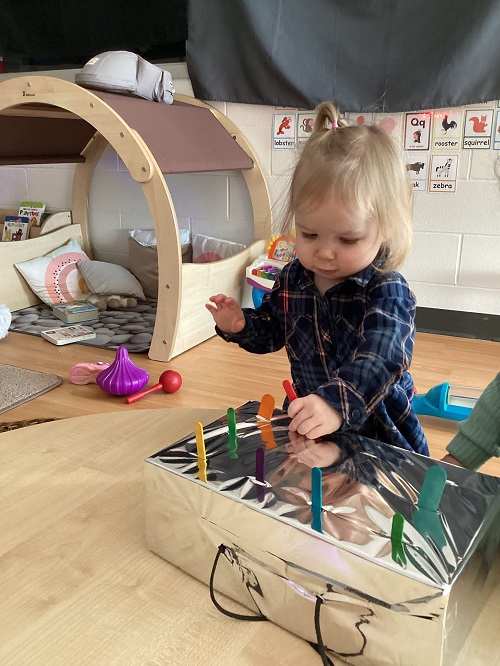 A child exploring the shiny box