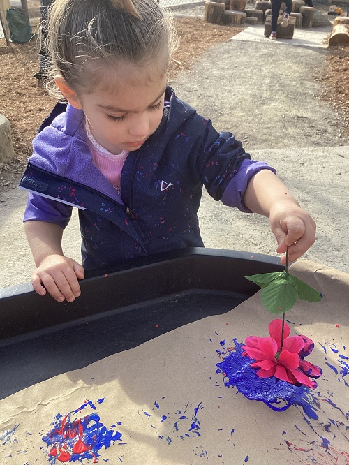 A child painting with a flower