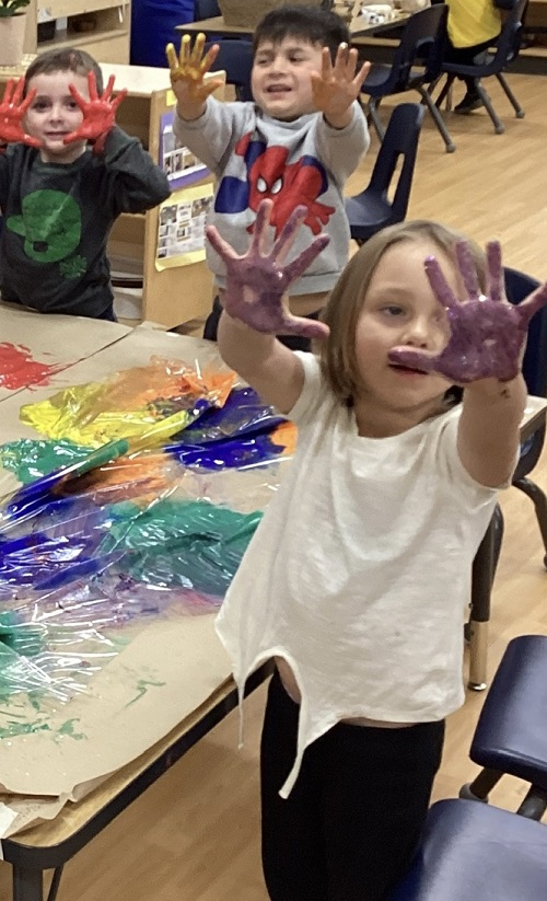 Children showing their paint covered hands