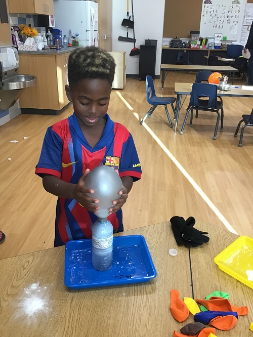 A school age child participating in a science experience