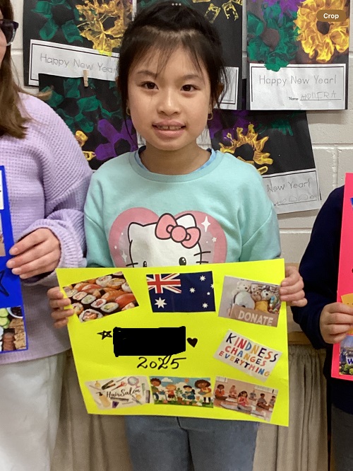 A child displaying the vision board they created.
