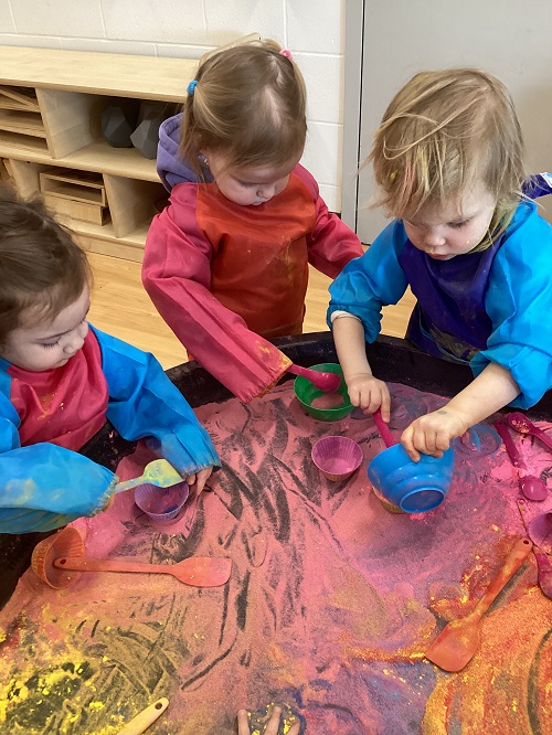 Toddler children playing with colourful powder for Holi