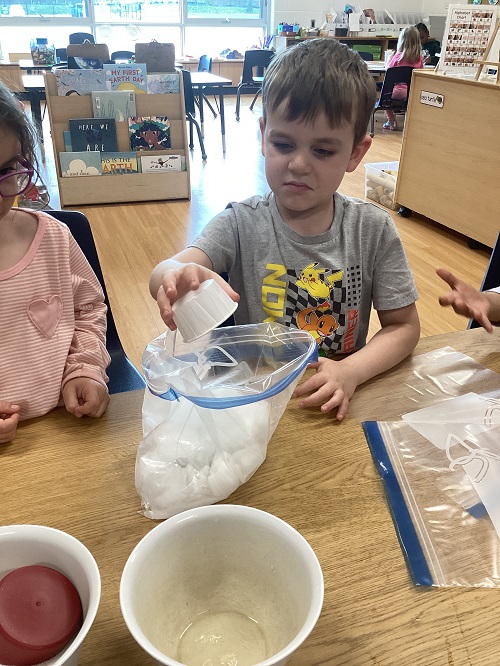 A child pouring ingredients into a bag.