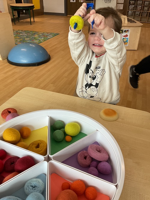 excited child with tongs
