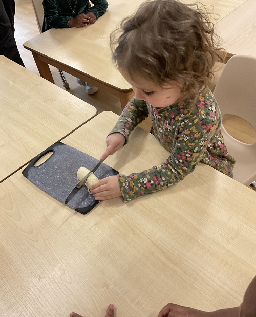 child chopping banana