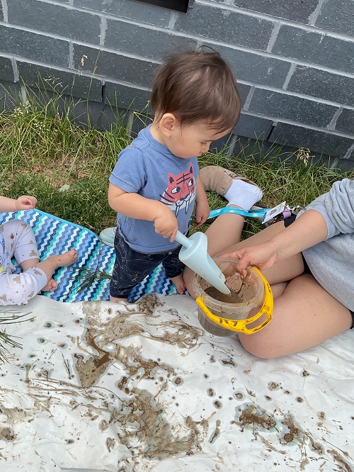 child outdoors with a shovel
