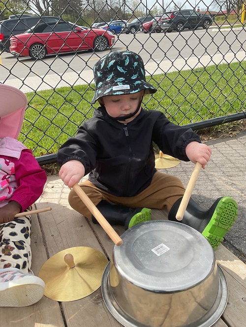 little boy banging the drum 2 sticks