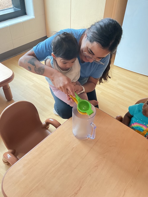 educator helping child squeeze