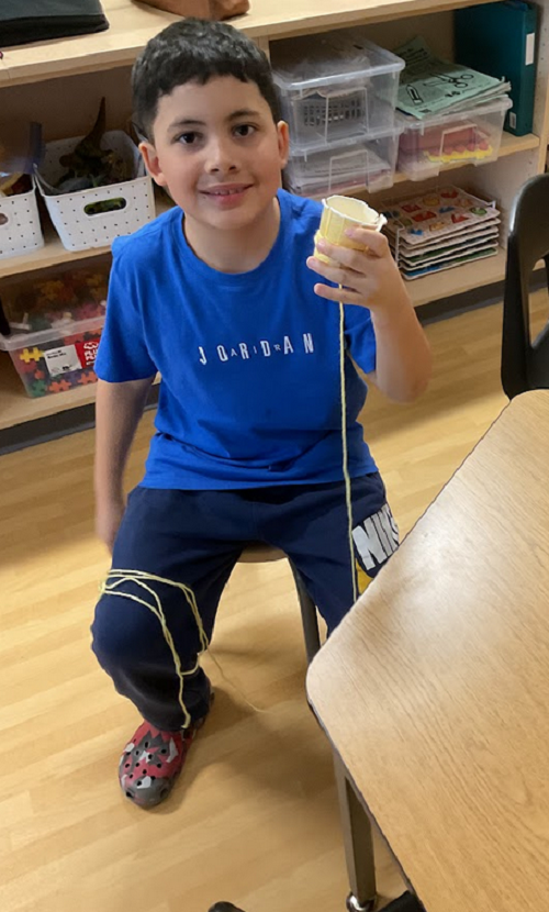 child showing his crochet