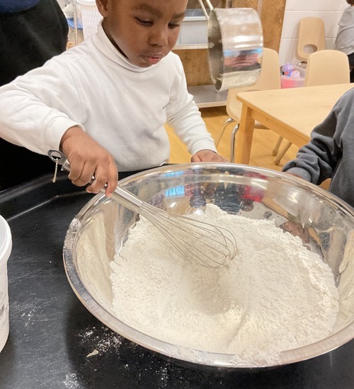 child mixing a bowl