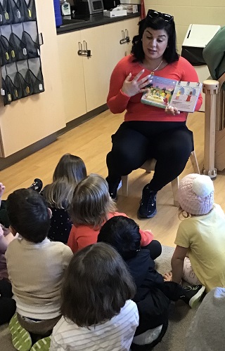 A parent reading a story about Eid to the preschool group