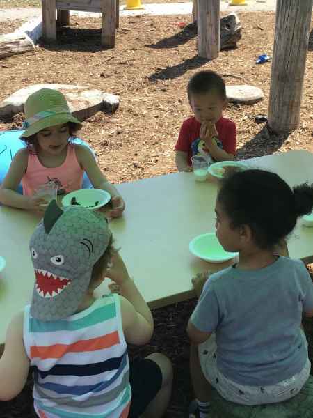 children enjoying a snack outside