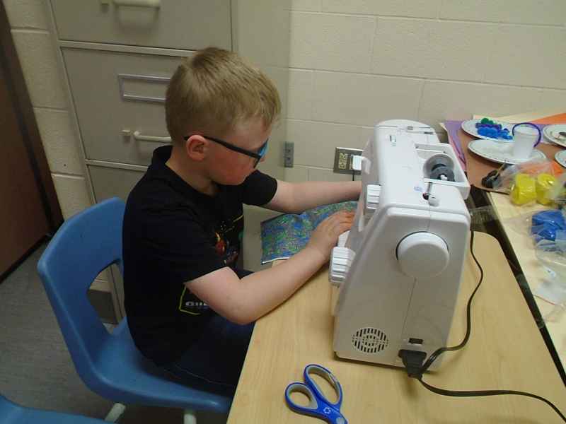 boy using a sewing machine