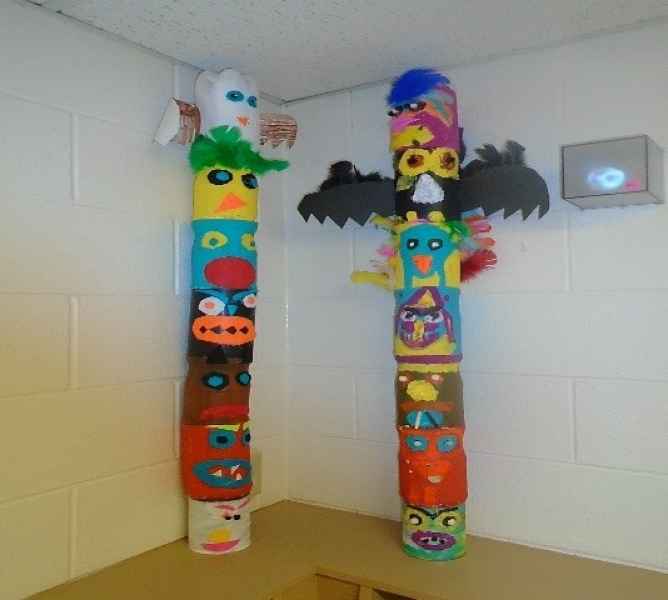 two homemade totem poles