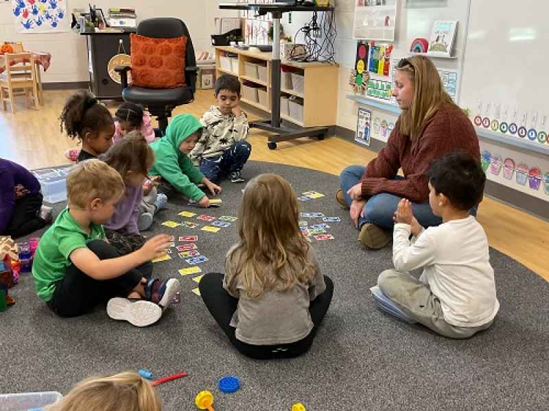children playing a game with an educator at risingoaks st.patrick