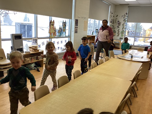 children walking around a long table