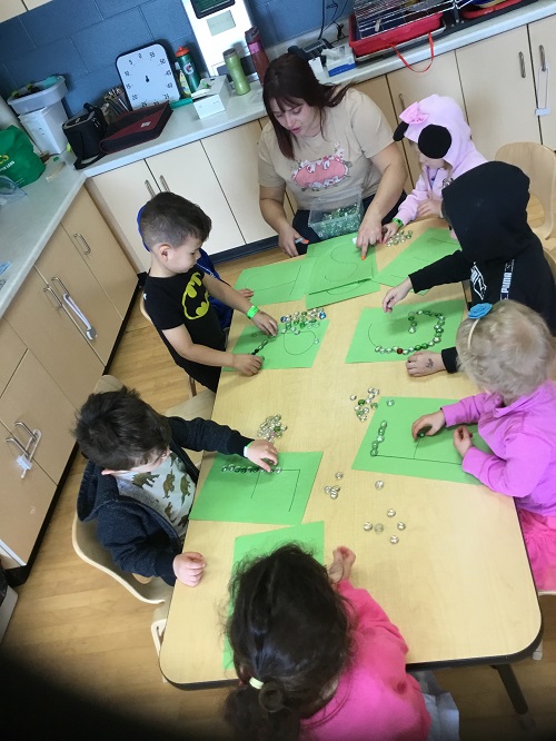 group at table tracing letters
