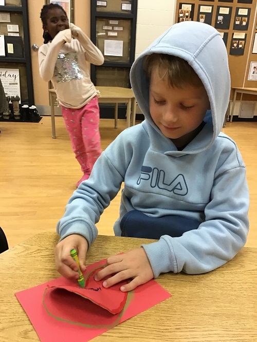 single child drawing a heart