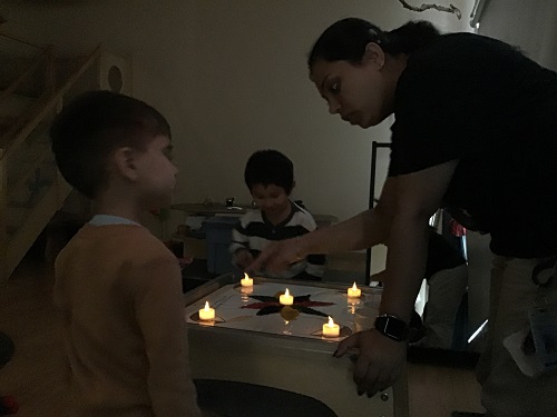Jaspreet, Liam and Mason looking at the lights on the Rangoli creative. 