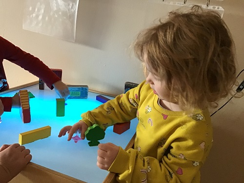 Little girl spins top