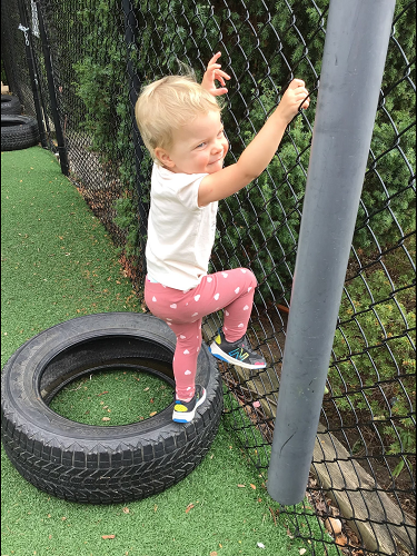 child climbing on a tire
