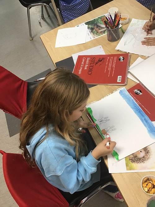 child working on her drawing