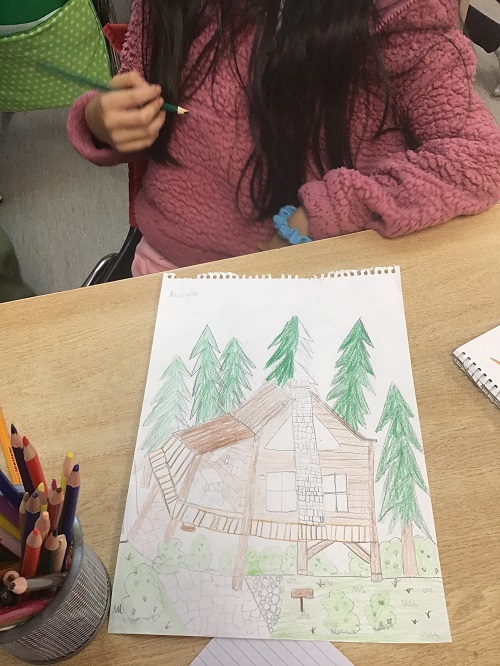 child showing off her drawing