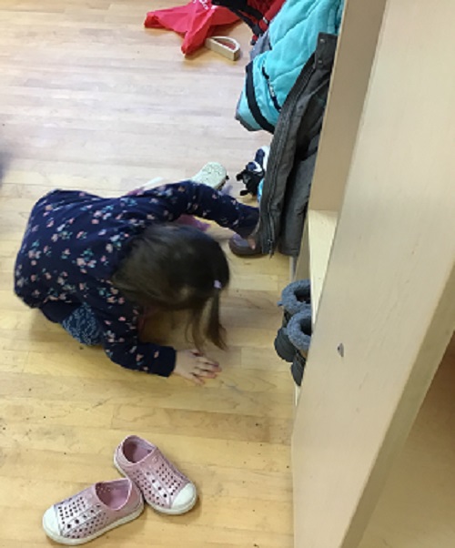 Child getting their own boots.