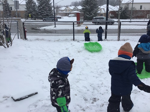 Children pulling sleds.