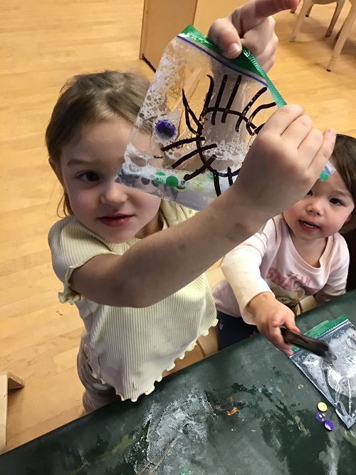Child showing "spider" sensory bag.