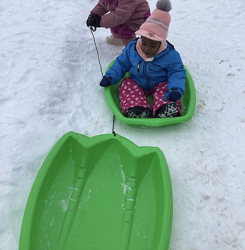 Children waiting for their trun to be pulled on the sled.