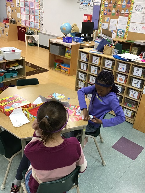 Child shuffling "Hednanz" cards.