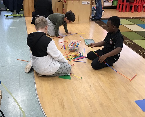 Children building with straws.