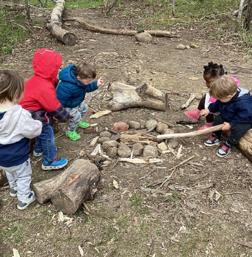 Children pretending to have a camp fire.